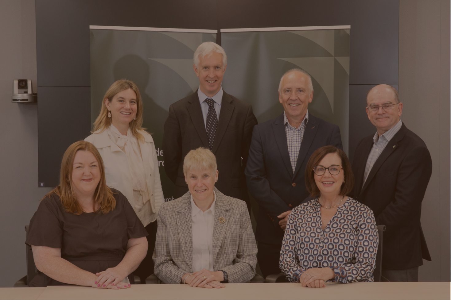 7 members of the Research Ireland board in a group sitting and standing.